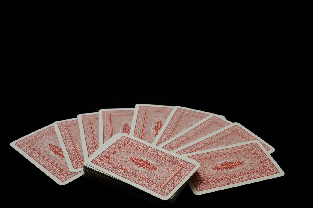 red-cards-of-a-deck-on-a-black-studio-background-concept-of-gambling-and-playing-poker-or-other-card_t20_4e7vGO
